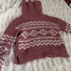 Teddy pink turtleneck sweater.